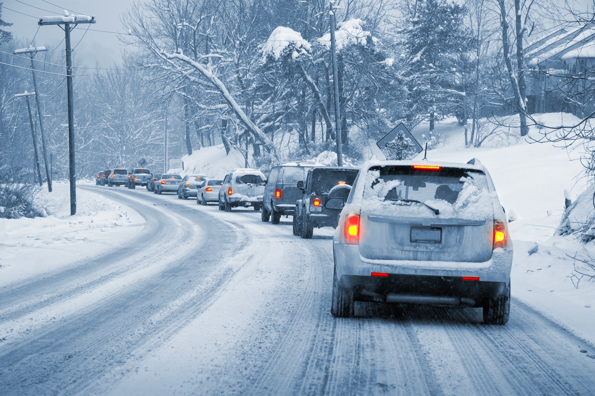 A line of cars stuck in traffic in winter conditions.