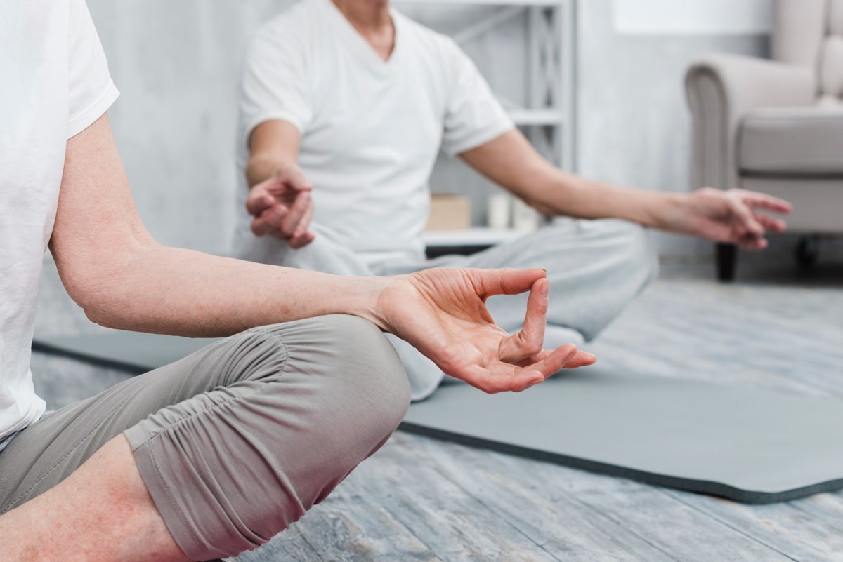 A picture of two people arms and legs in yoga poses.